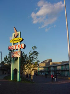 The google-style marquee of the Lorraine Motel, with the hotel in the background and the blue sky above.