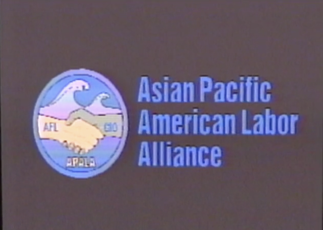 Title card from a video with a grainy black background and blue text reading "Asian Pacific American Labor Alliance." There is a circular logo next to the text of two hands shaking labeled AFL and CIO and a wave crashing over them with APALA written below.